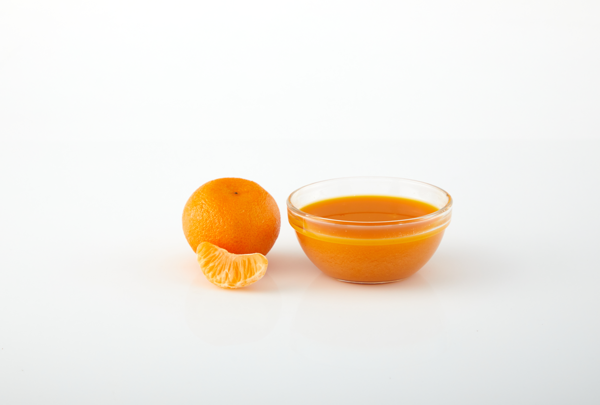 Tangerine aseptic fruit puree in packaging for breweries, hard seltzers, beverages, ice cream, sauces, desserts, and food manufacturing applications